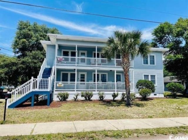 view of front of home with a front yard and a porch