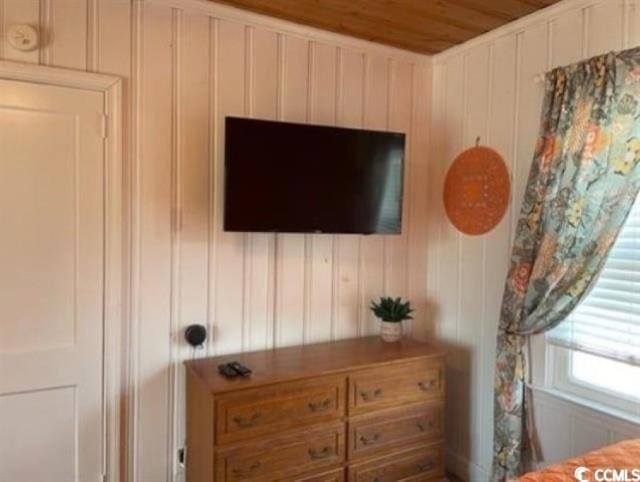 room details featuring wooden walls and wooden ceiling