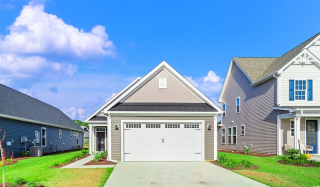 view of front facade featuring a front lawn, a garage, and central AC