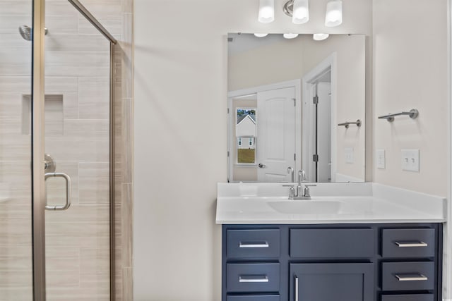 bathroom featuring an enclosed shower and vanity