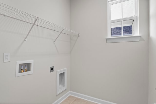 clothes washing area featuring washer hookup, electric dryer hookup, and light tile patterned flooring