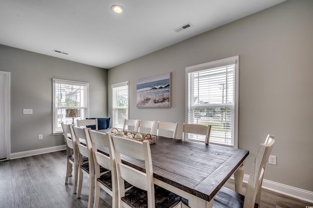 kitchen featuring light stone counters, a sink, dark wood finished floors, stainless steel appliances, and visible vents