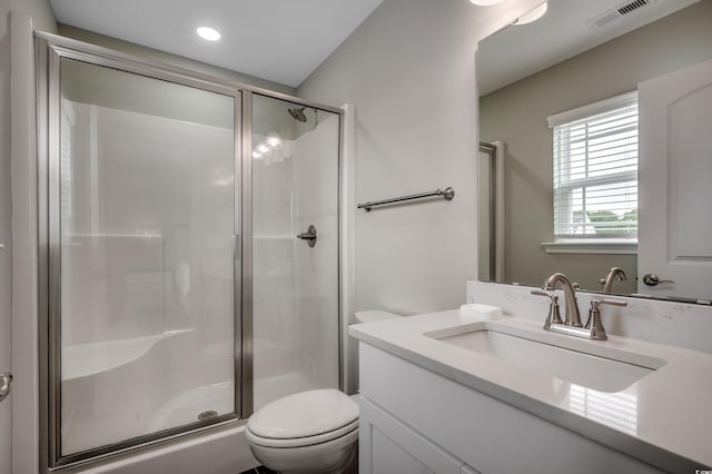 bathroom featuring vanity, toilet, recessed lighting, and a stall shower