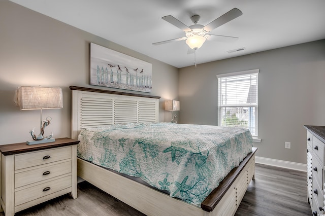 unfurnished room featuring baseboards, ceiling fan, and dark wood-type flooring
