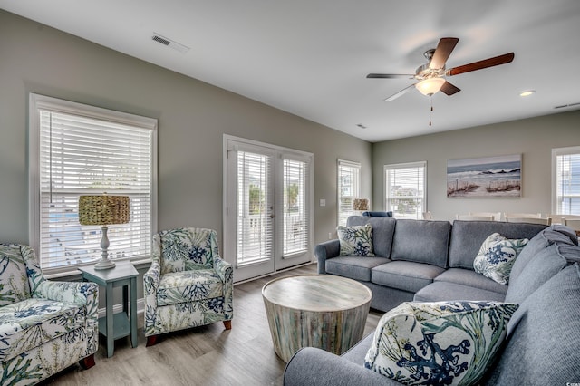 unfurnished room with visible vents, dark wood finished floors, ceiling fan, and baseboards