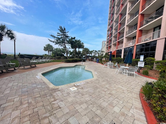 view of swimming pool featuring a patio area