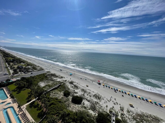 bird's eye view with a water view and a beach view