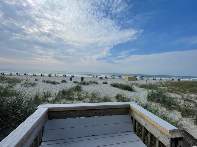 exterior space featuring a water view and a beach view