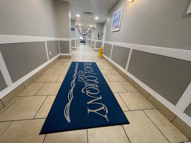 hallway with light tile patterned floors