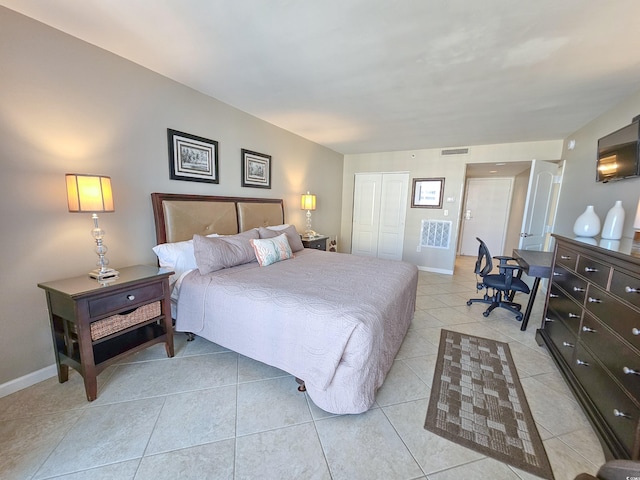 bedroom featuring a closet and light tile patterned flooring