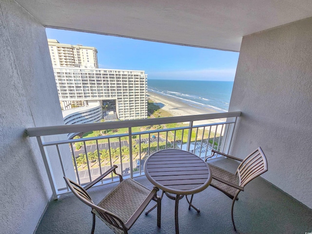 balcony with a beach view and a water view