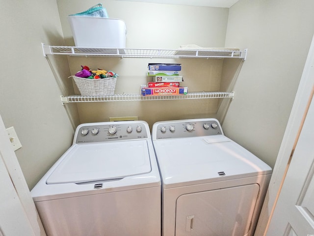 clothes washing area with washer and dryer