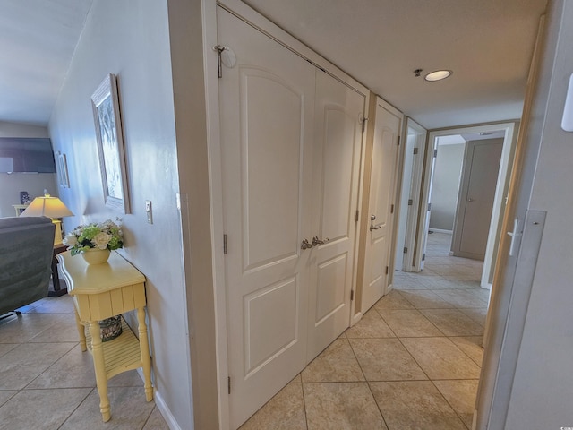 corridor with light tile patterned floors