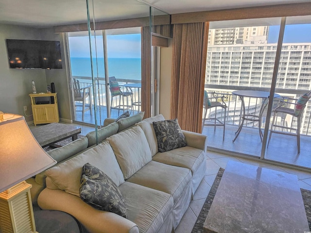 living room with a wall of windows, light tile patterned flooring, and a water view