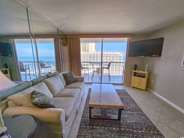 living room featuring a wall of windows and light tile patterned floors