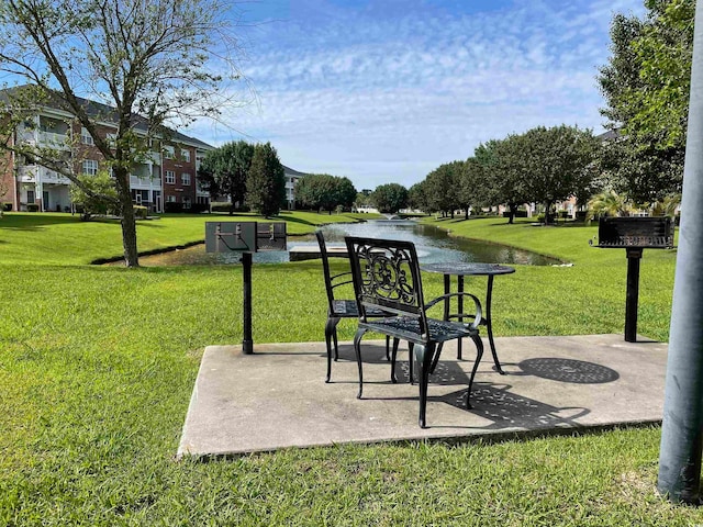 exterior space with a water view and a yard