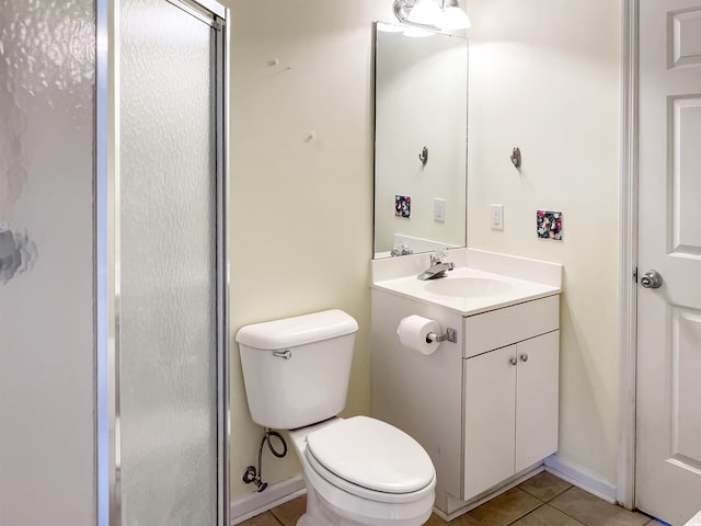 bathroom with tile flooring, vanity, and toilet