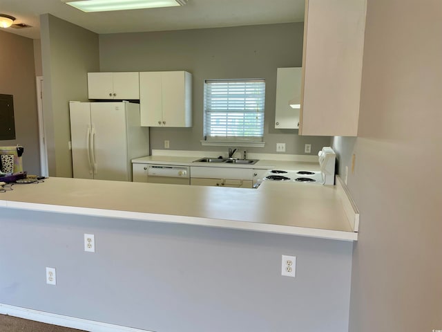 kitchen with white appliances, white cabinets, and sink