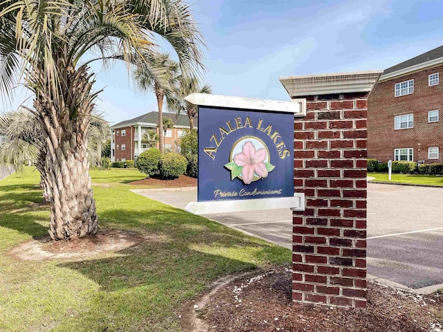 community / neighborhood sign with a lawn