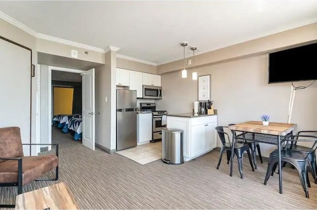 kitchen with stainless steel appliances, crown molding, white cabinetry, light colored carpet, and pendant lighting