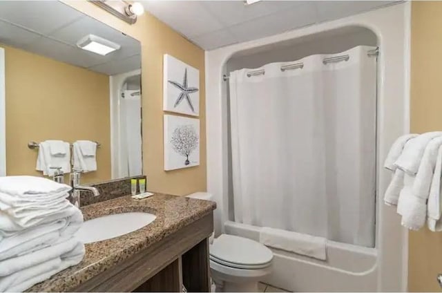 full bathroom with tile floors, shower / bath combo, oversized vanity, and toilet