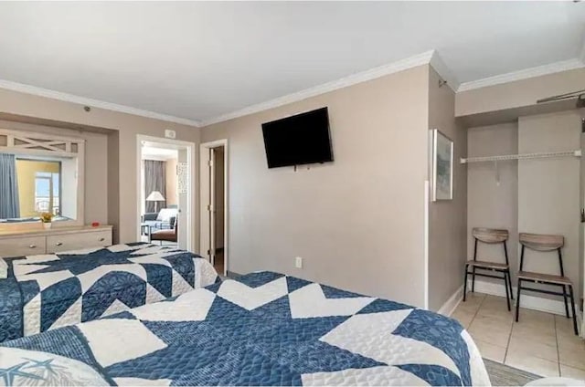 tiled bedroom with crown molding and a closet