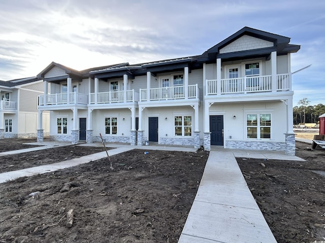 view of front of home with a balcony