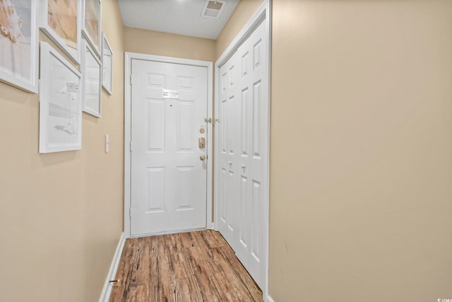 entryway with hardwood / wood-style floors