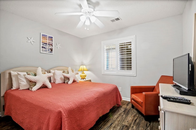 bedroom with dark hardwood / wood-style flooring and ceiling fan