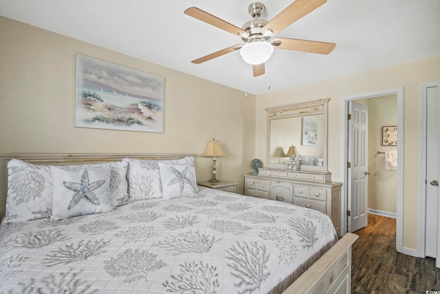 bedroom with dark hardwood / wood-style flooring and ceiling fan