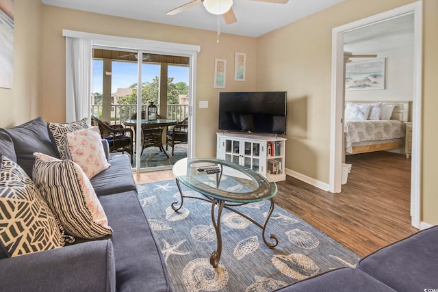 living room featuring ceiling fan and hardwood / wood-style flooring