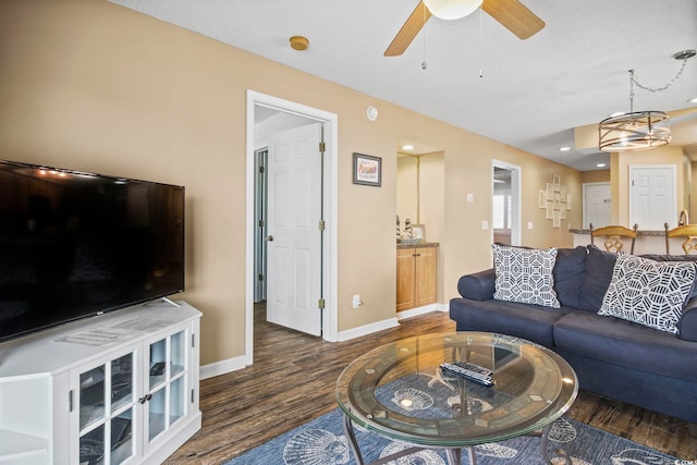 living room with dark hardwood / wood-style floors and ceiling fan