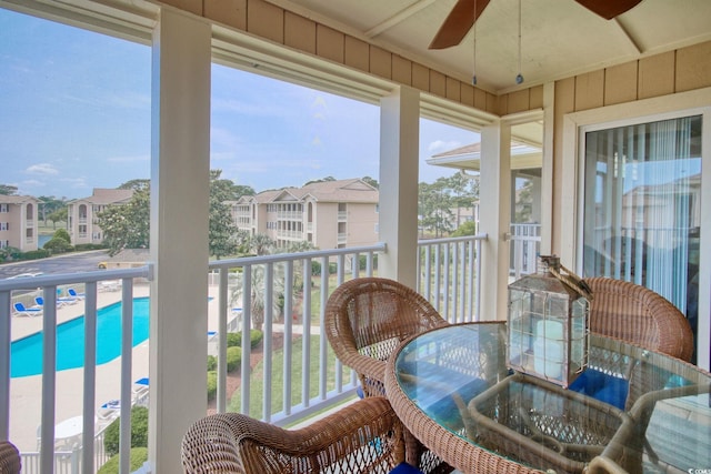 sunroom featuring ceiling fan