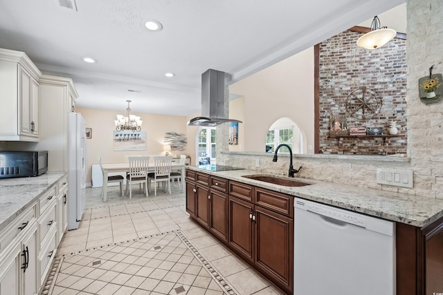 kitchen featuring dark brown cabinetry, white cabinetry, sink, island range hood, and black appliances