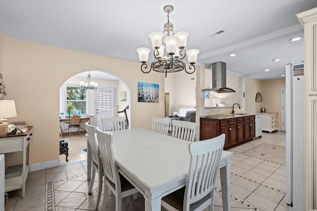 tiled dining area with sink and a notable chandelier