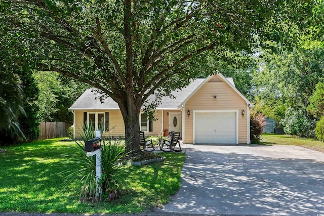 view of front of property featuring a garage and a front lawn