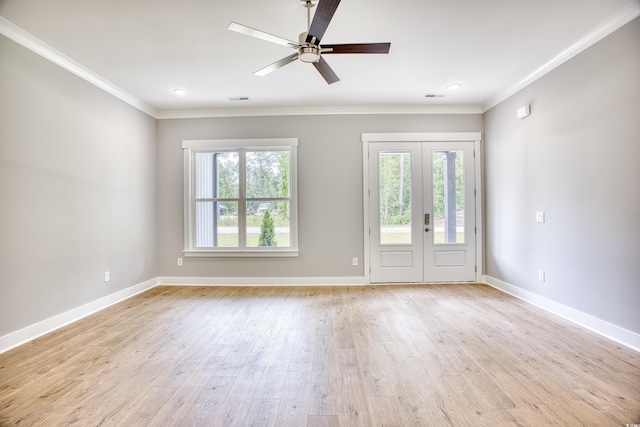 empty room with ceiling fan, a healthy amount of sunlight, ornamental molding, and light hardwood / wood-style flooring