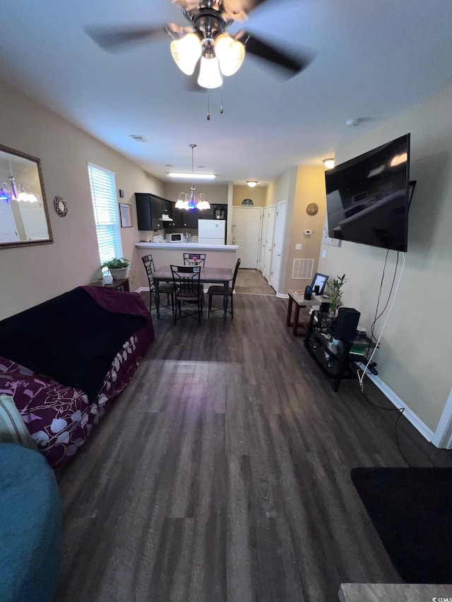 living room with dark hardwood / wood-style floors and ceiling fan