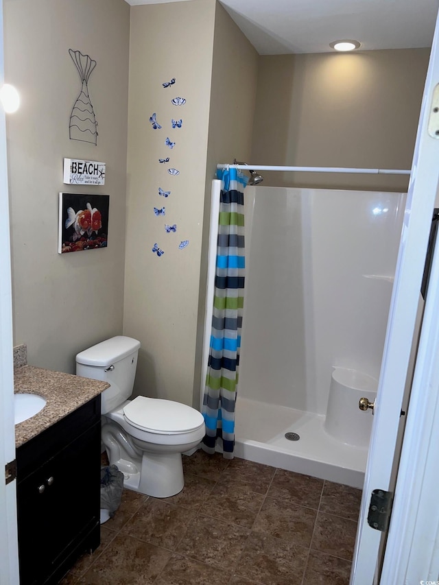 bathroom featuring vanity, a shower with curtain, and toilet