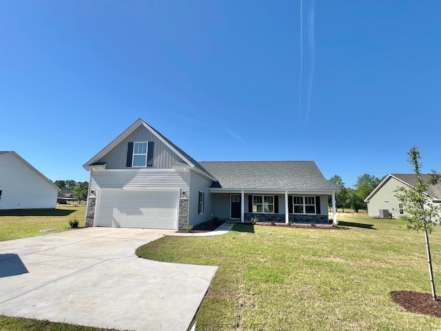 view of front of home with a front yard and a garage