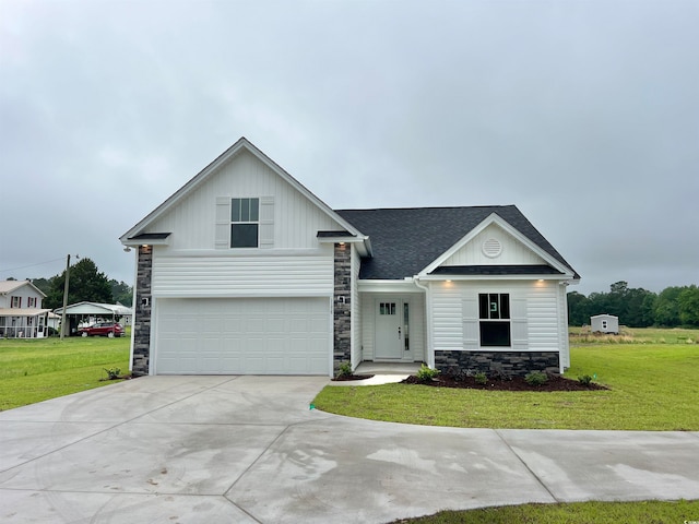 view of front of property featuring a front lawn and a garage