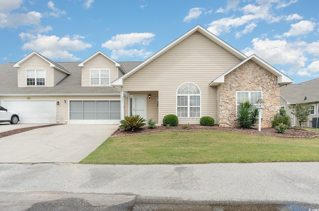 front of property with a front yard and a garage