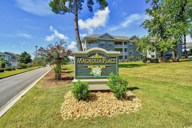 community sign featuring a lawn