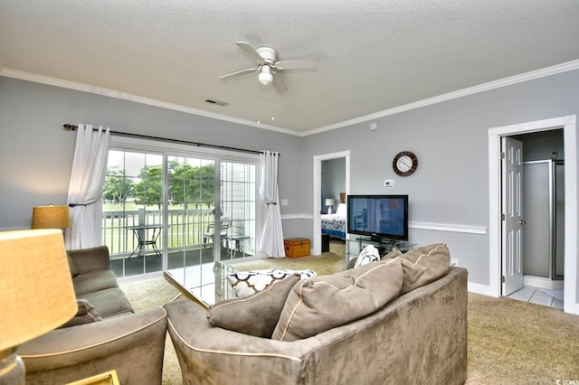 living room featuring tile floors, a textured ceiling, ornamental molding, and ceiling fan