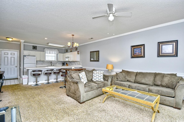 living room featuring crown molding, a textured ceiling, ceiling fan with notable chandelier, and light colored carpet