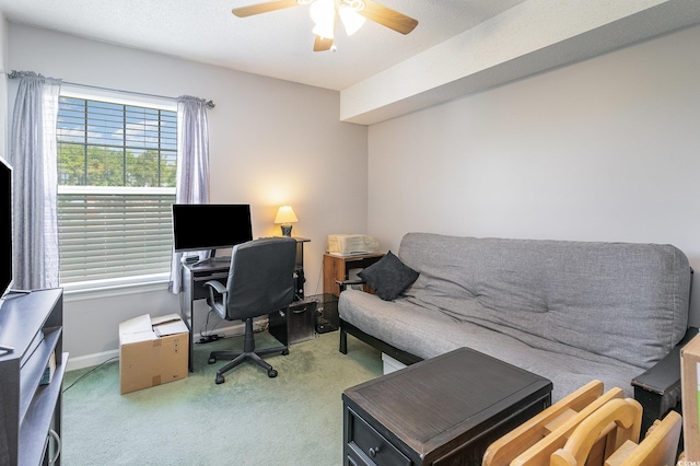 carpeted office space featuring ceiling fan