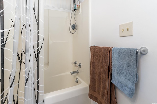 bathroom with shower / bath combo with shower curtain