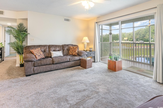 carpeted living room featuring ceiling fan