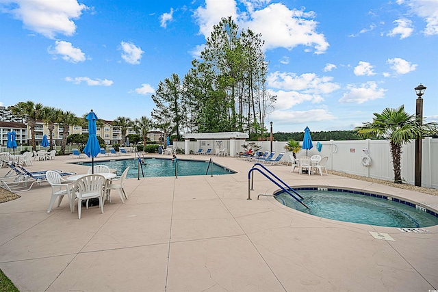 view of swimming pool featuring a patio area and a community hot tub