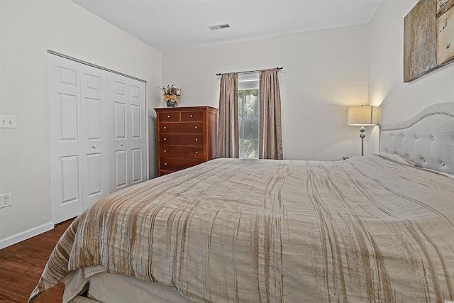 bedroom featuring dark hardwood / wood-style flooring and a closet